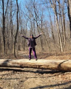 Me standing on log with arms open