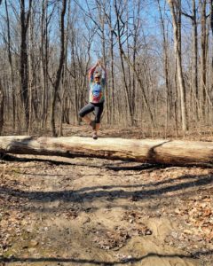 My friend on log in tree pose